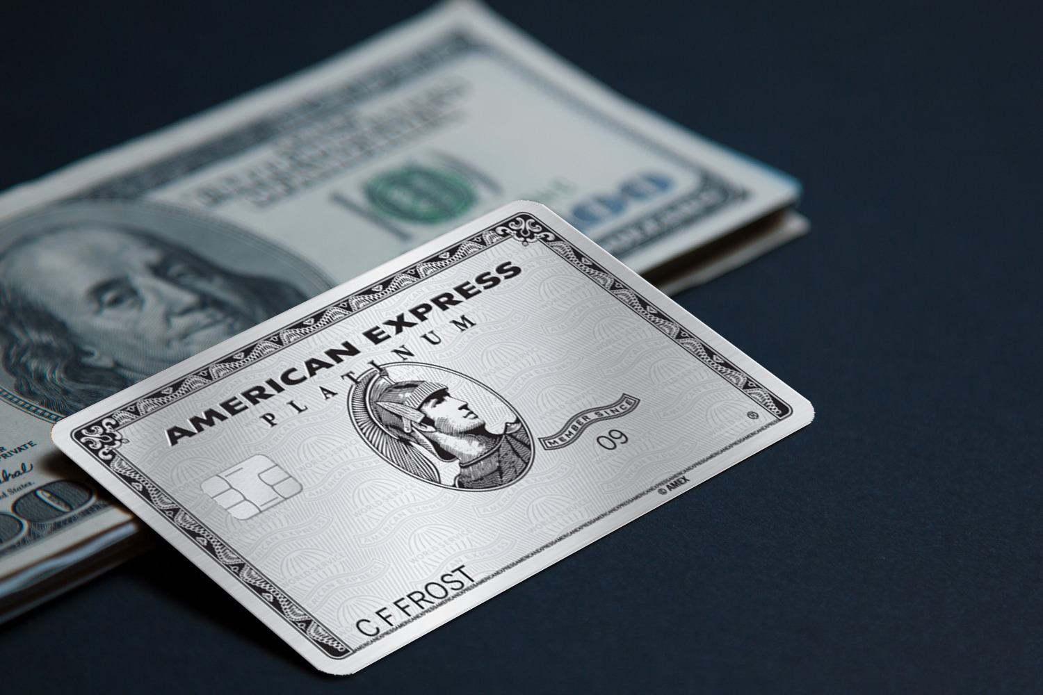 The Platinum Card from American Express with stash of dollars