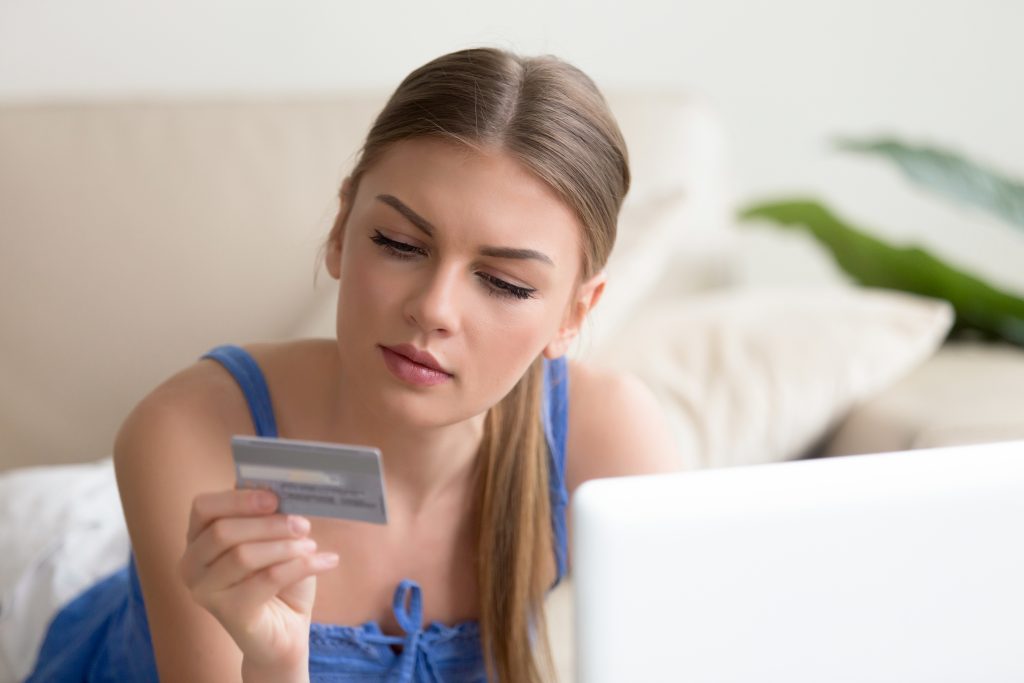woman not sure if to choose a secured or unsecured credit card